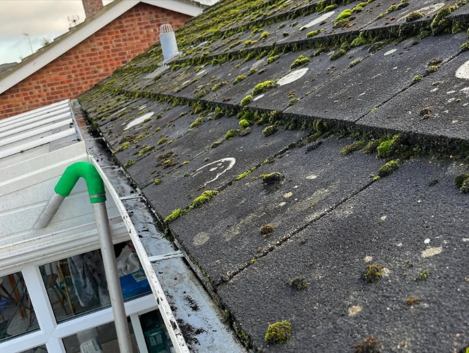 Gutter clearing equipment removing roof debris