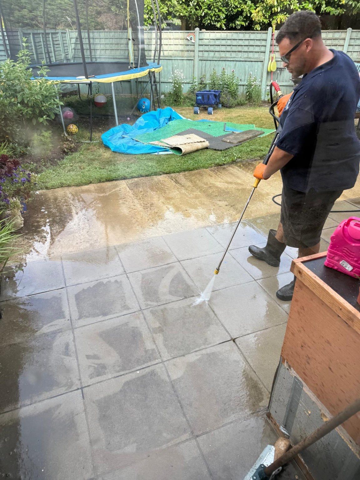 Pressure washing a patio during cleaning